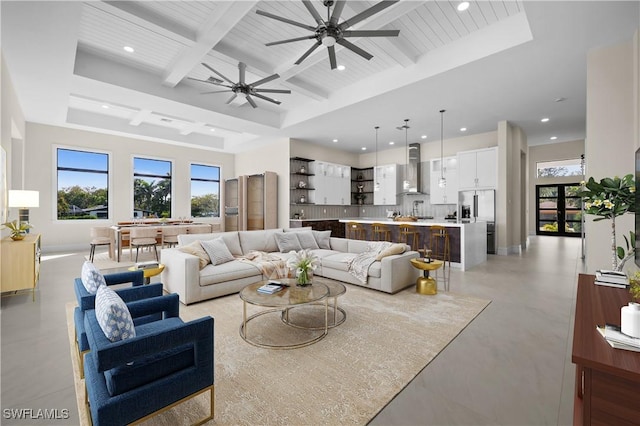 living room featuring baseboards, ceiling fan, beam ceiling, recessed lighting, and coffered ceiling