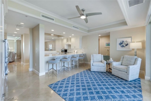 living area featuring crown molding, recessed lighting, a raised ceiling, visible vents, and baseboards