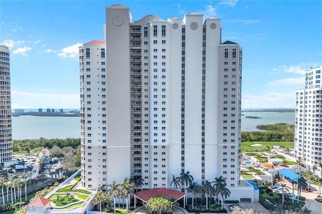 view of building exterior with a view of city and a water view