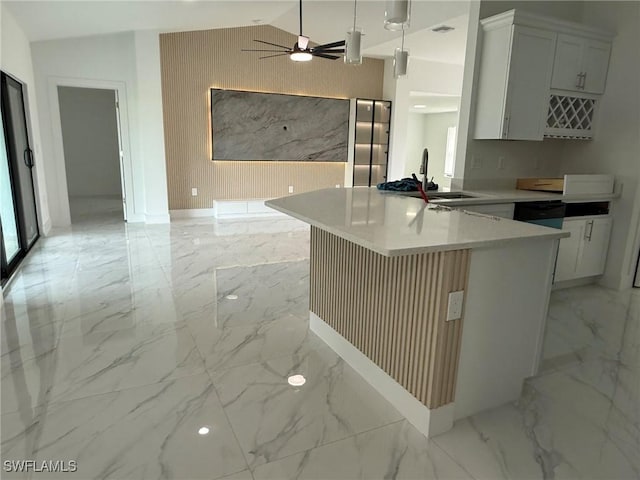 kitchen featuring marble finish floor, light countertops, white cabinetry, and decorative light fixtures