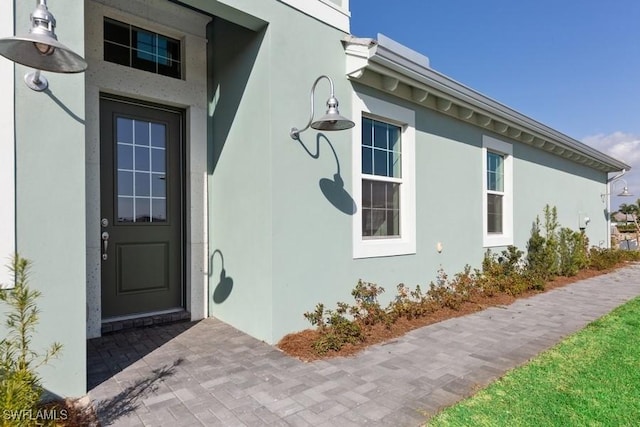 entrance to property with stucco siding