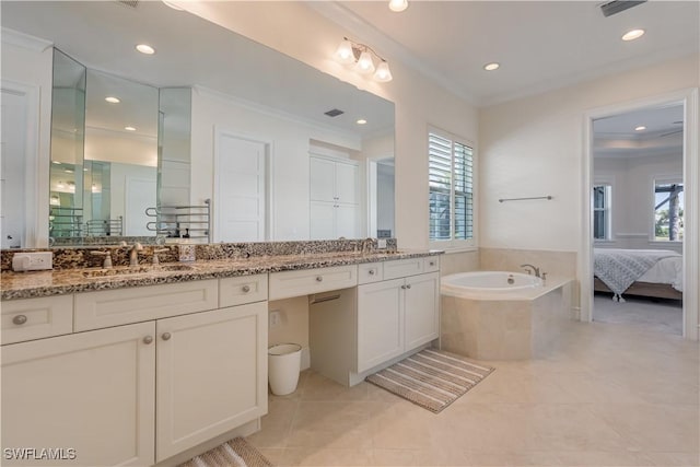 bathroom featuring ornamental molding, tile patterned flooring, a garden tub, and vanity