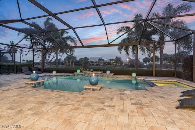 outdoor pool with glass enclosure and a patio area