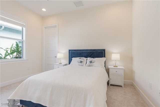 bedroom with recessed lighting, light carpet, and baseboards