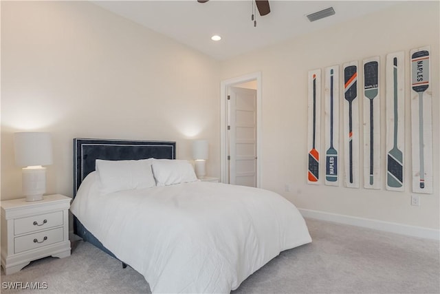 bedroom with light carpet, visible vents, and baseboards