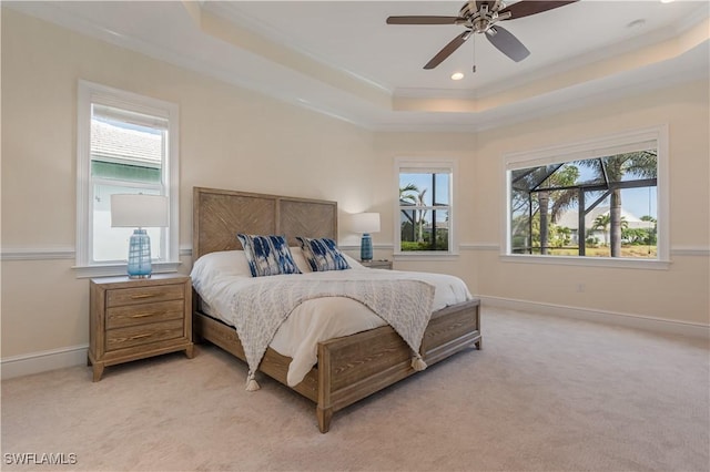 bedroom with baseboards, light colored carpet, a tray ceiling, crown molding, and recessed lighting