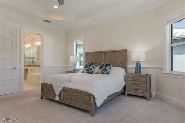 carpeted bedroom featuring recessed lighting, visible vents, ornamental molding, a raised ceiling, and ensuite bath