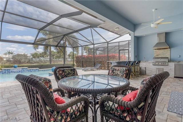 view of patio / terrace with glass enclosure, outdoor dining area, an outdoor kitchen, and a grill