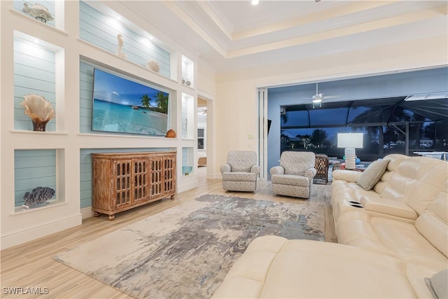 living area with a sunroom and wood finished floors