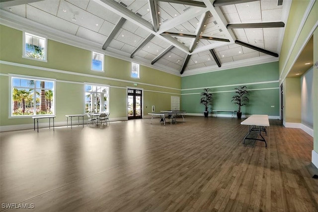 workout area with a high ceiling, baseboards, wood finished floors, and recessed lighting