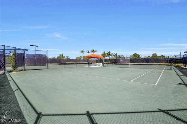 view of tennis court with fence