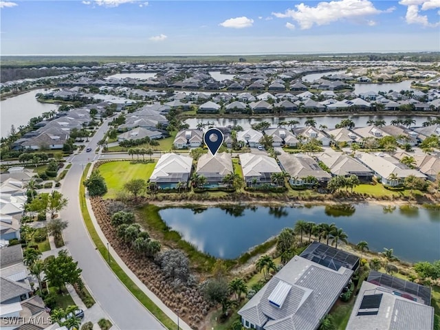 drone / aerial view featuring a water view and a residential view