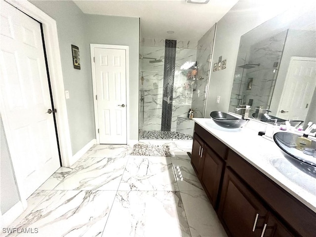 bathroom featuring double vanity, marble finish floor, a marble finish shower, and a sink