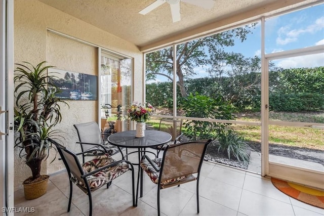 sunroom / solarium featuring ceiling fan