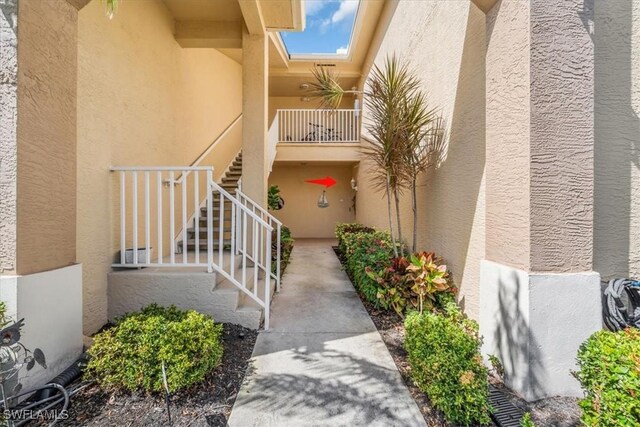 doorway to property featuring stucco siding