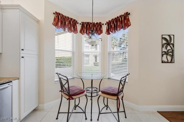 dining room with baseboards, a chandelier, and light tile patterned flooring