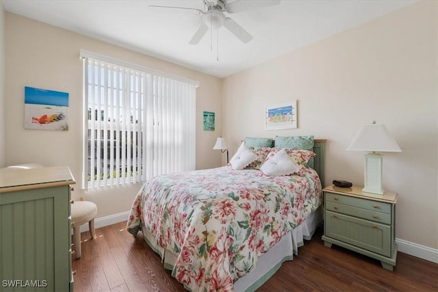 bedroom featuring dark wood-type flooring, a ceiling fan, and baseboards