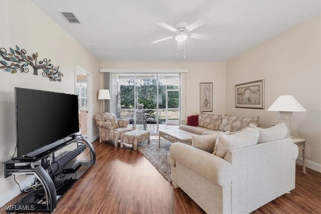 living room with ceiling fan, wood finished floors, visible vents, and baseboards