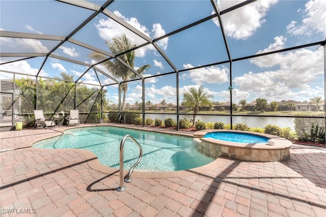 view of pool with glass enclosure, a patio area, a pool with connected hot tub, and a water view