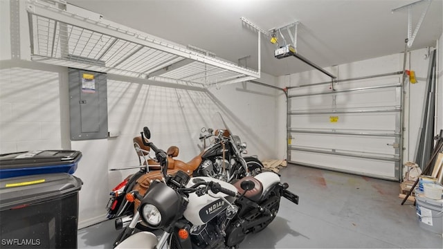 garage with electric panel and a garage door opener