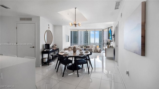 dining room featuring a chandelier, visible vents, and light tile patterned floors