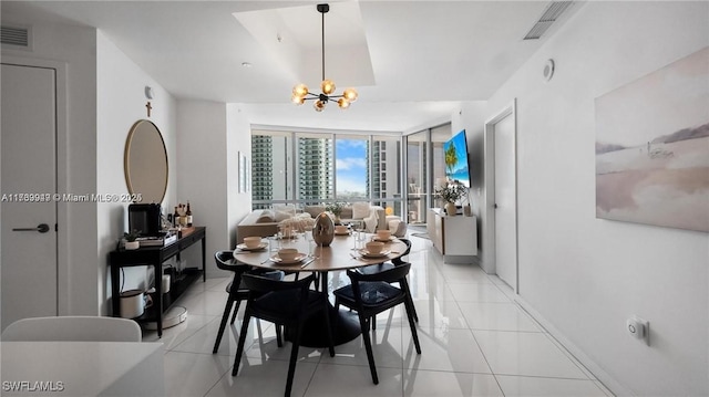 dining room with floor to ceiling windows, visible vents, a notable chandelier, and light tile patterned flooring