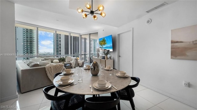 dining area featuring visible vents, expansive windows, a city view, a notable chandelier, and light tile patterned flooring