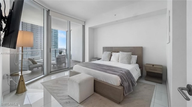 bedroom with a wall of windows, access to outside, and light tile patterned floors