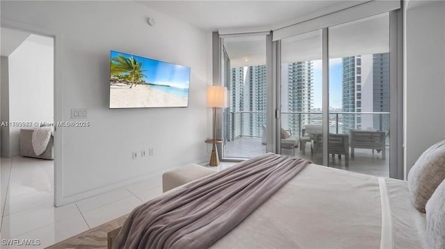 tiled bedroom featuring expansive windows and baseboards