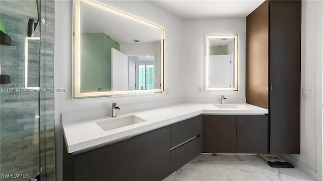 full bathroom with marble finish floor, double vanity, a sink, and a shower stall