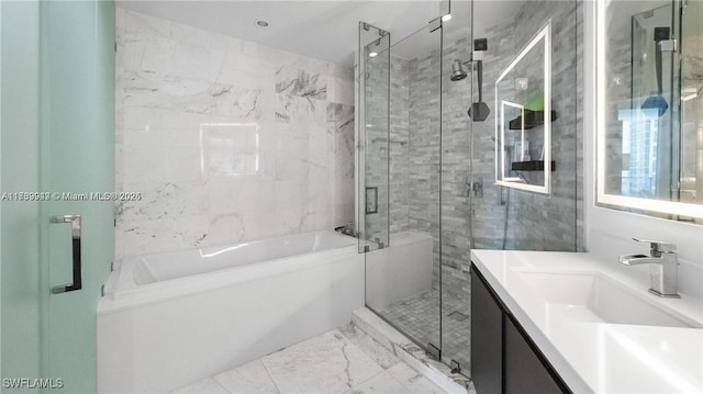 bathroom with a stall shower, marble finish floor, vanity, and a bath