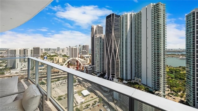 balcony featuring a city view and a water view