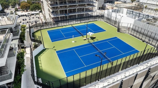 view of tennis court featuring fence