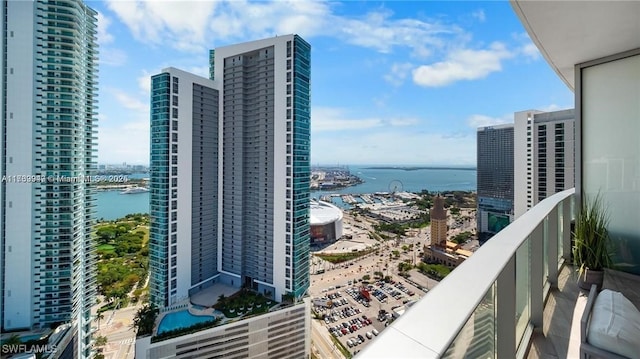 balcony with a water view and a city view