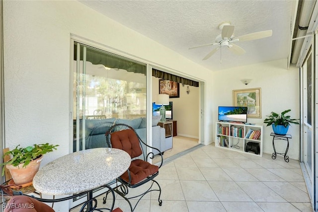 sunroom featuring a ceiling fan