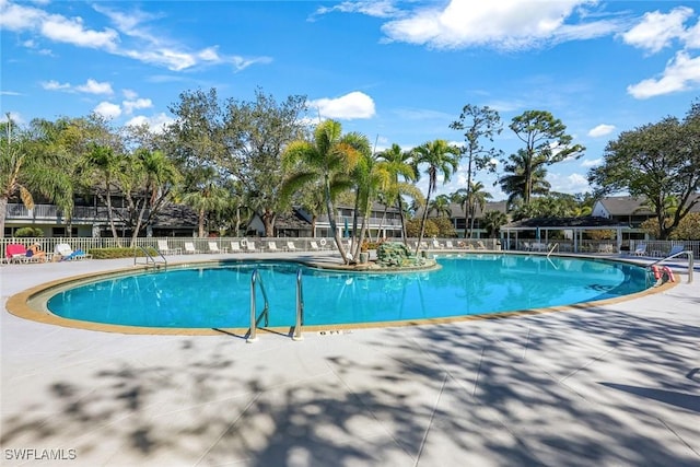 community pool featuring a patio area and fence