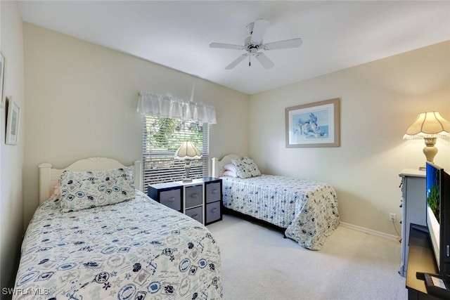 carpeted bedroom featuring baseboards and a ceiling fan