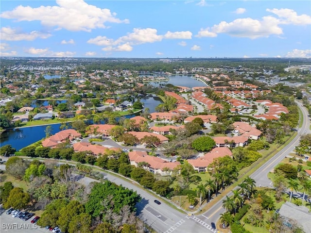 birds eye view of property with a residential view and a water view