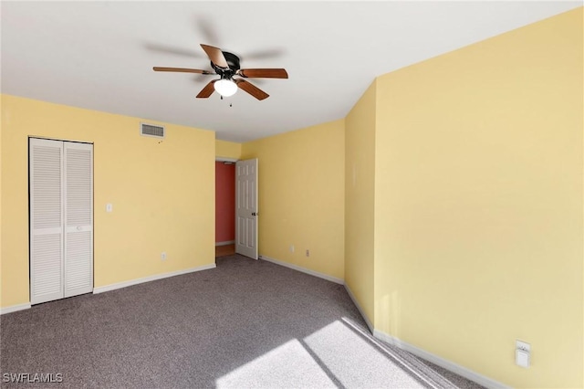 carpeted empty room with a ceiling fan, baseboards, and visible vents