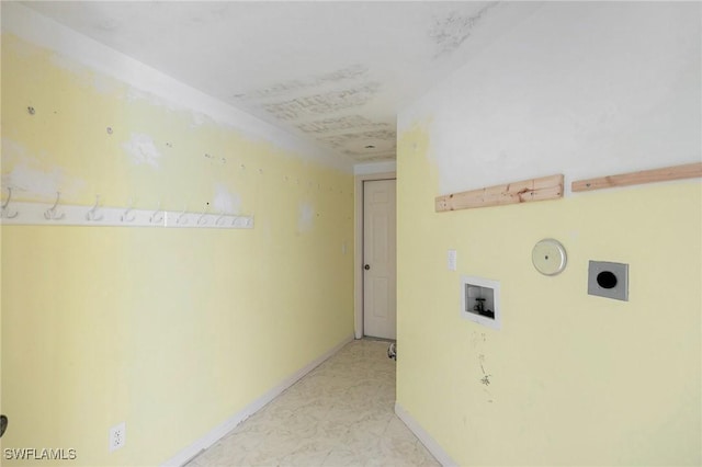 corridor featuring marble finish floor and baseboards