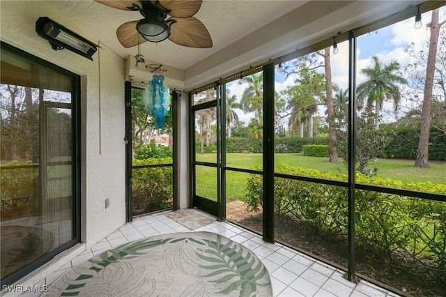 unfurnished sunroom featuring plenty of natural light and a ceiling fan