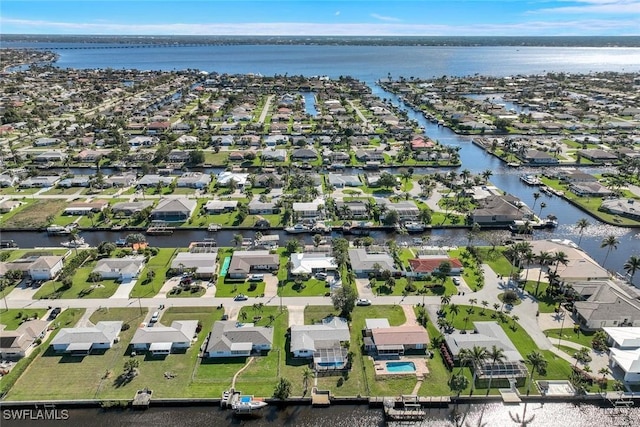 drone / aerial view with a residential view and a water view