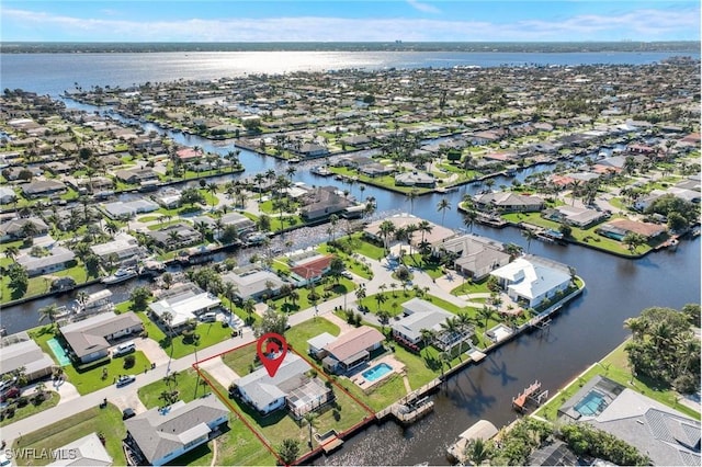 drone / aerial view featuring a residential view and a water view