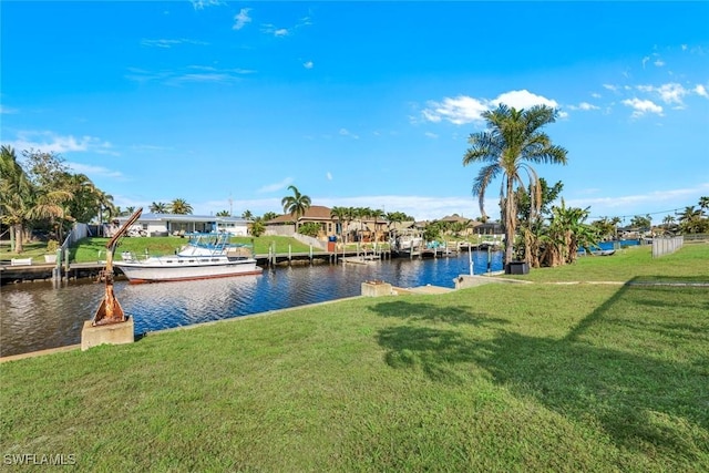 dock area with a lawn and a water view