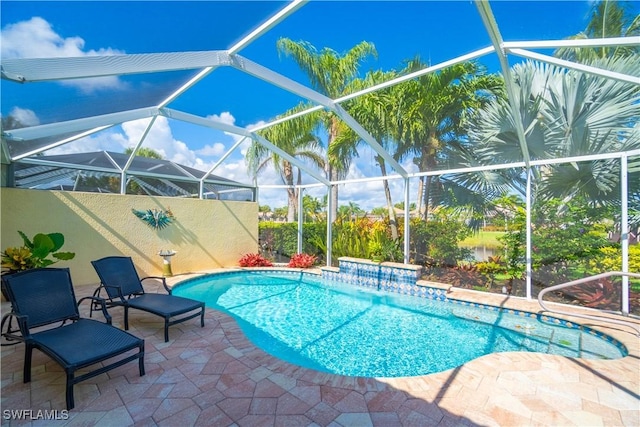 outdoor pool with a lanai and a patio