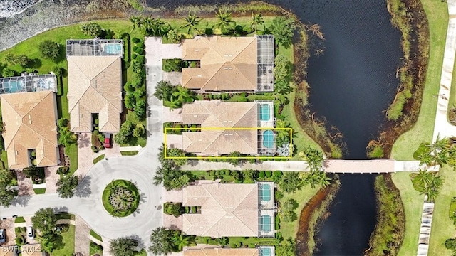 drone / aerial view featuring a residential view and a water view