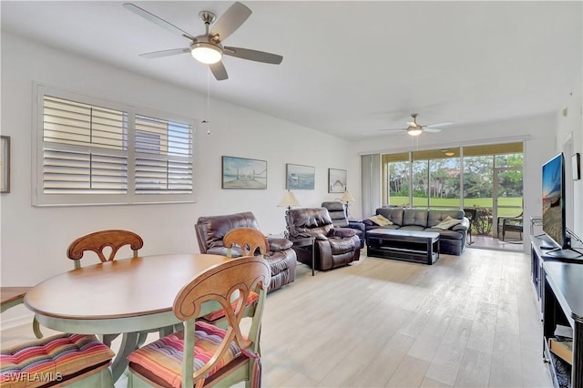 dining space with a ceiling fan and wood finished floors