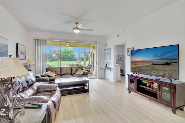 living area with wood finished floors and a ceiling fan