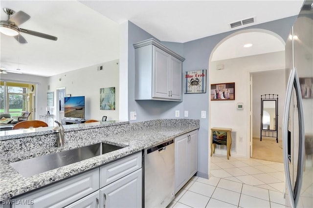 kitchen featuring light tile patterned floors, stainless steel appliances, a sink, visible vents, and a ceiling fan