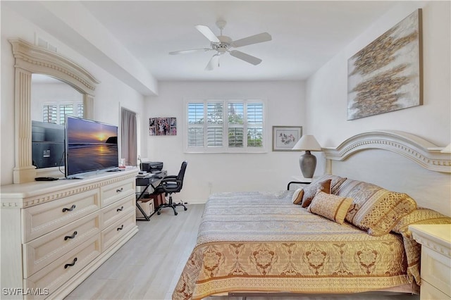 bedroom with multiple windows, ceiling fan, and light wood finished floors